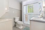 Full bathroom with updated shower and washer dryer
